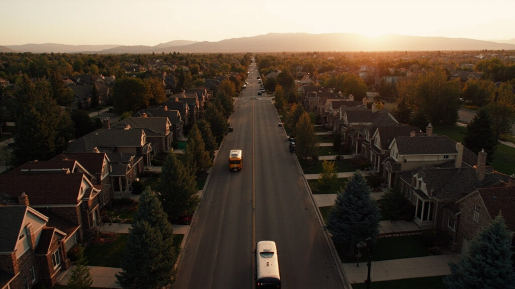 Greenwood Village Colorado neighborhood with Rocky Mountains, brick homes, and blue spruce trees at golden hour